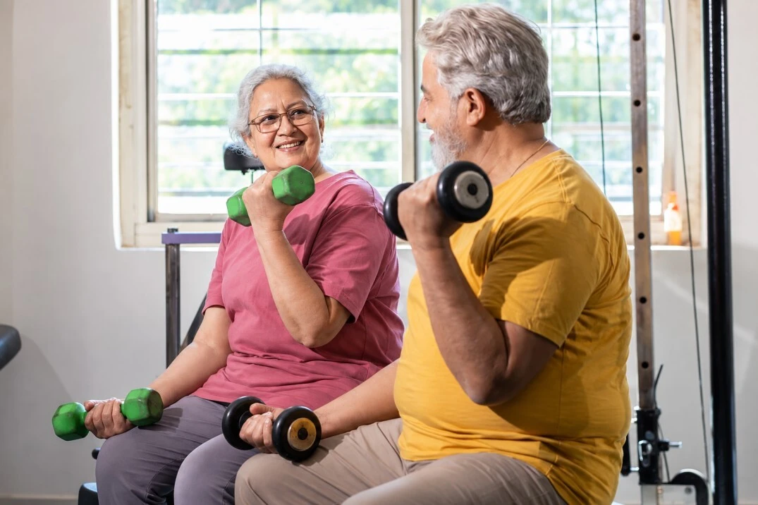 Residents exercising together in the fitness center at Grace Meadows